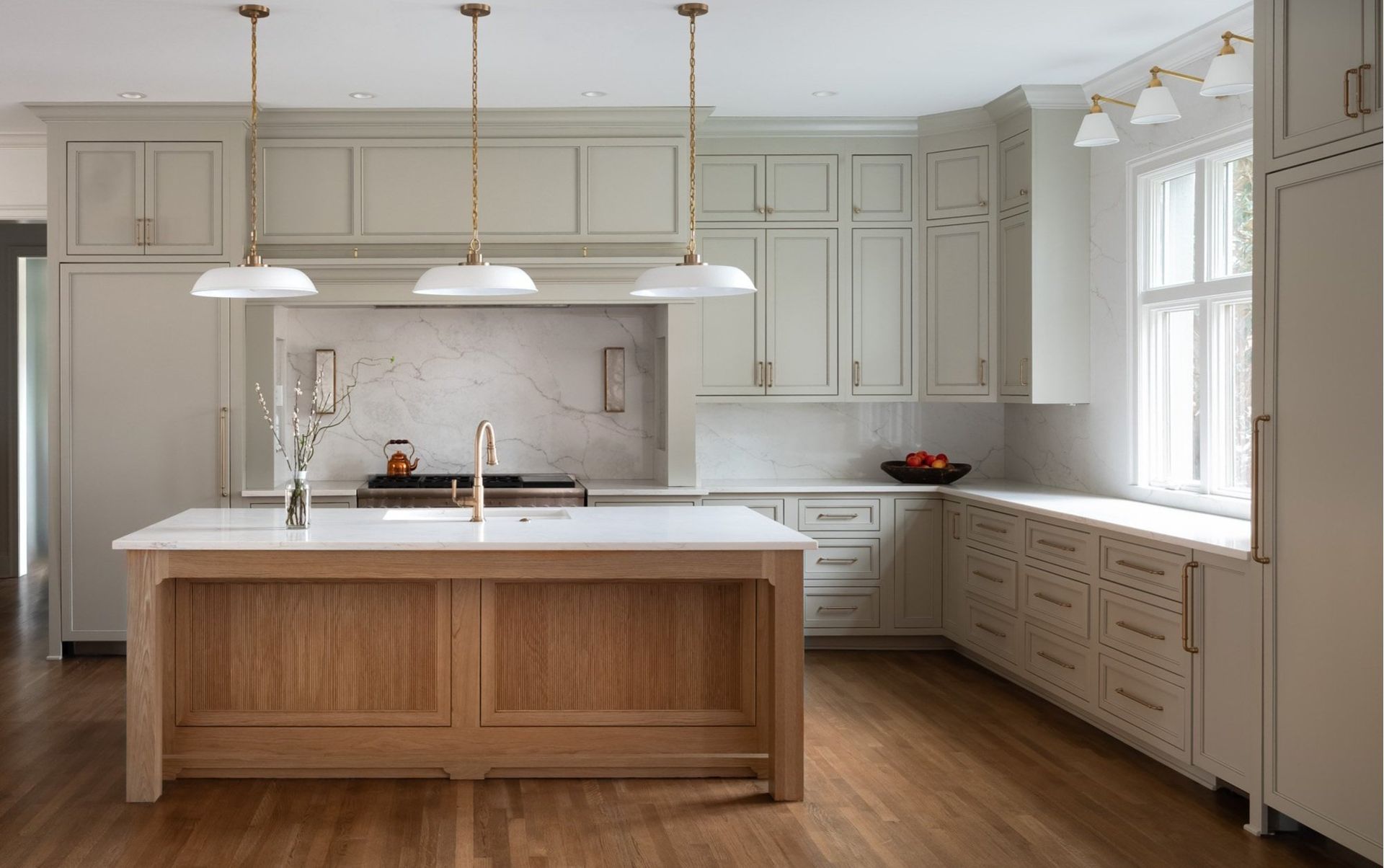 Gray painted kitchen with white oak island by Designer Cabinets