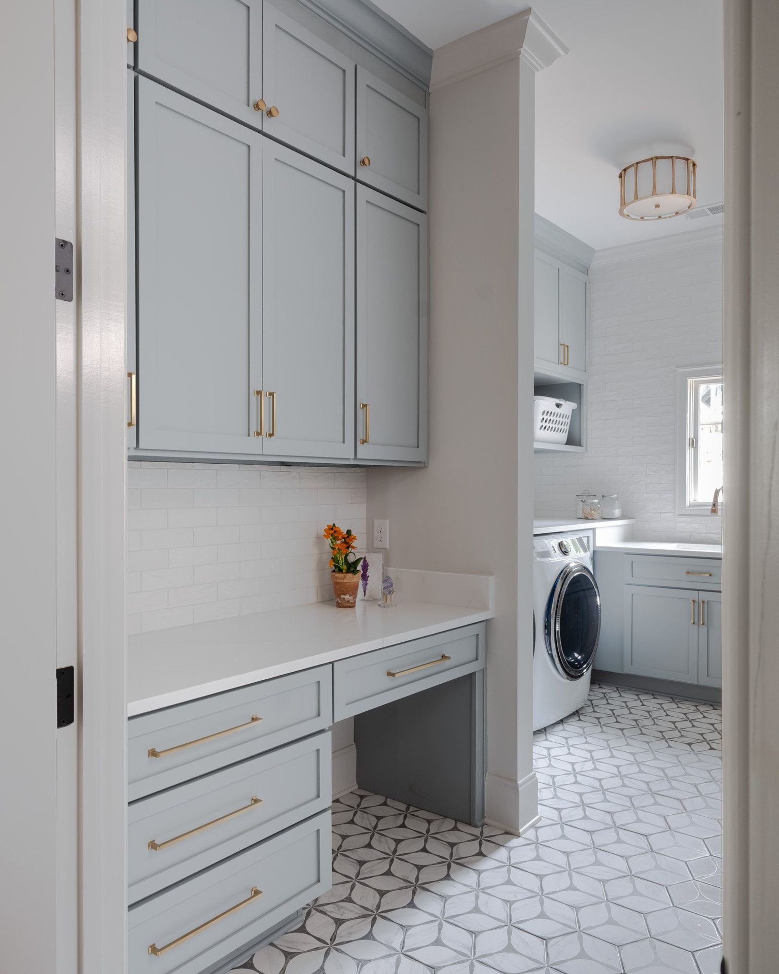 Gray painted kitchen with white oak island by Designer Cabinets