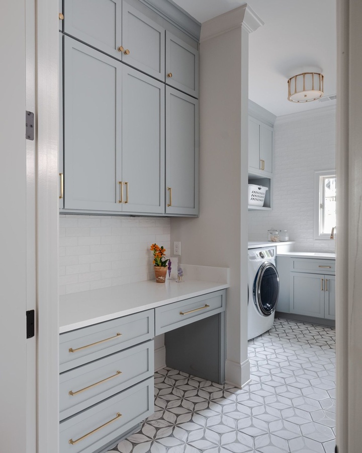 Blue shaker laundry cabinetry by Designer Cabinets