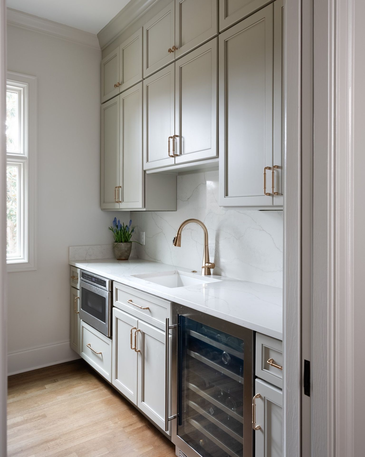 Gray painted kitchen with white oak island by Designer Cabinets