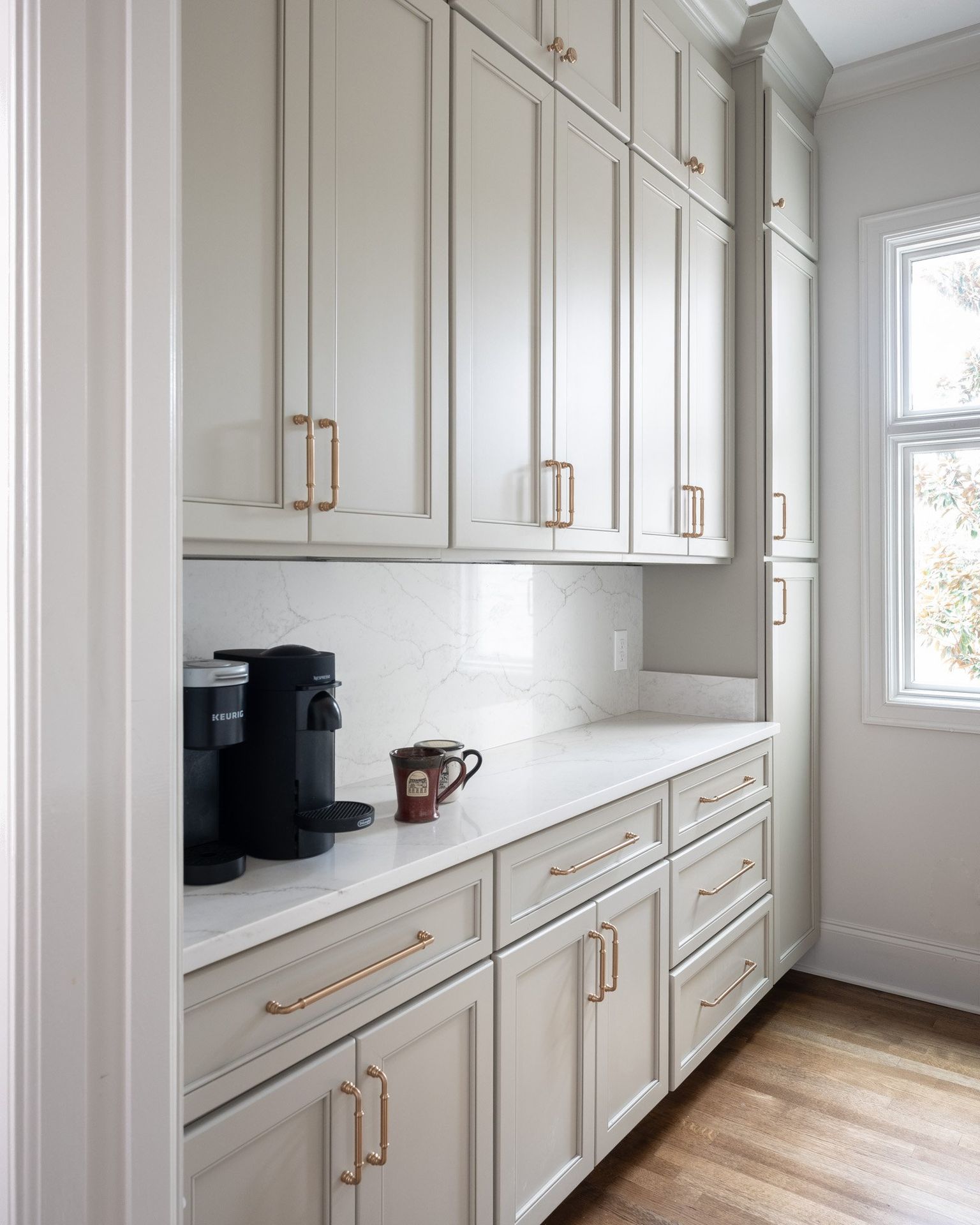 Gray painted kitchen with white oak island by Designer Cabinets