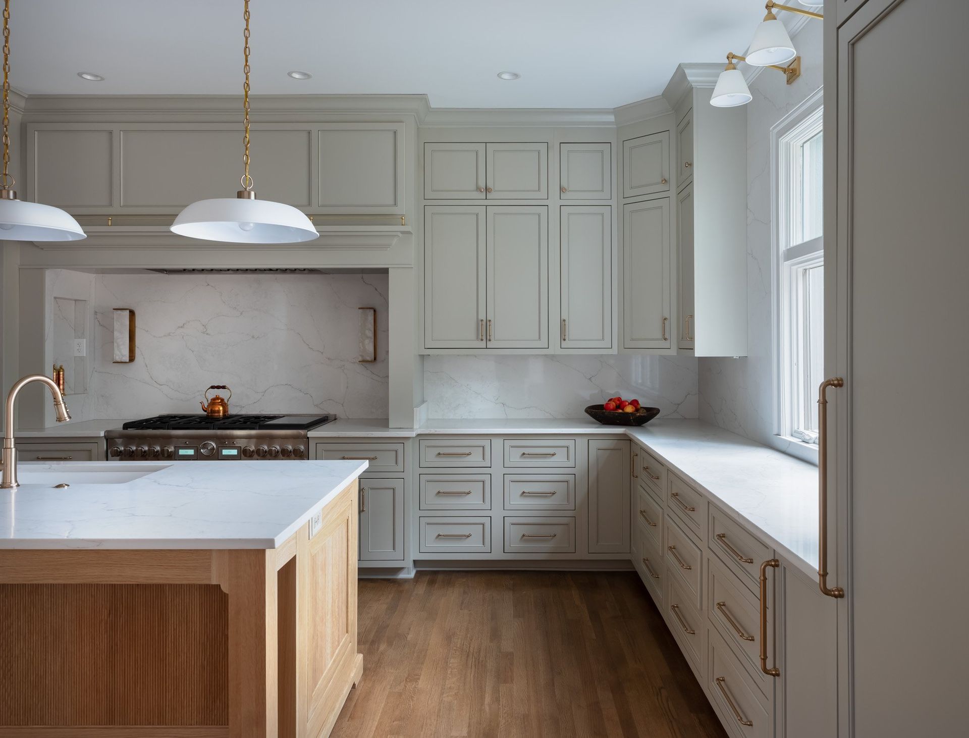 Gray painted kitchen with white oak island by Designer Cabinets