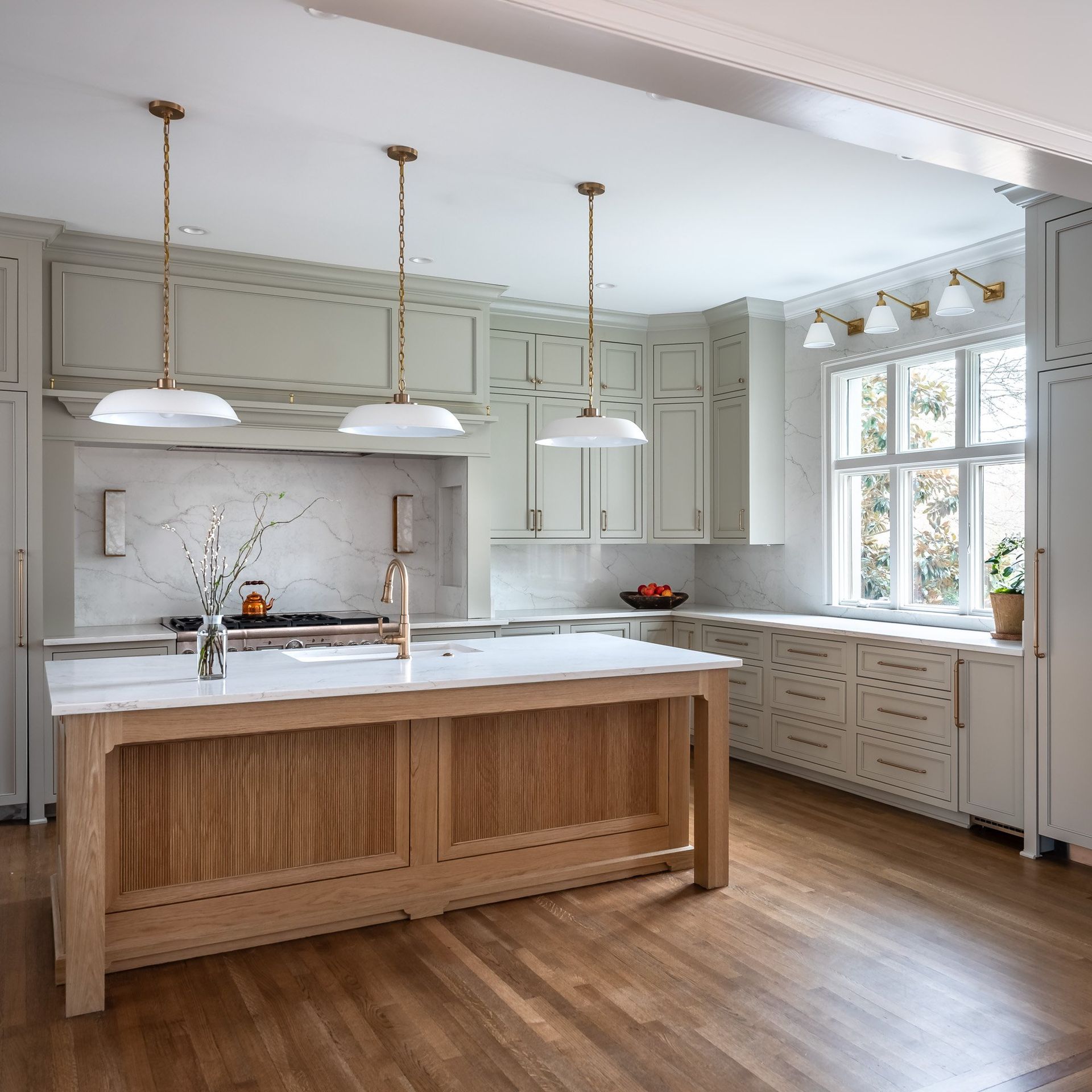 Gray painted kitchen with white oak island by Designer Cabinets