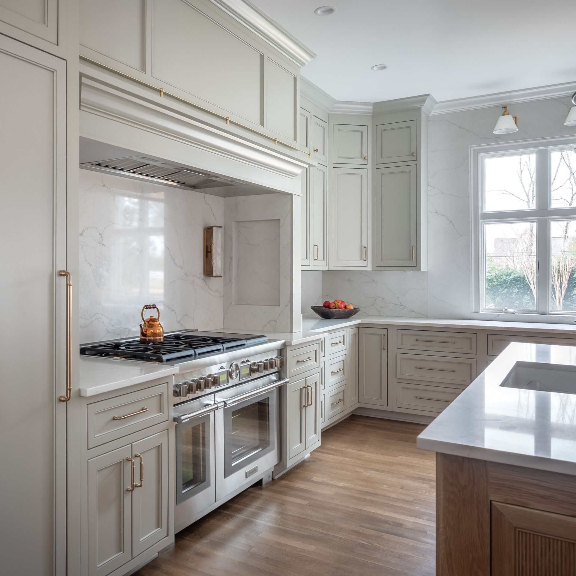 Gray painted kitchen with white oak island by Designer Cabinets