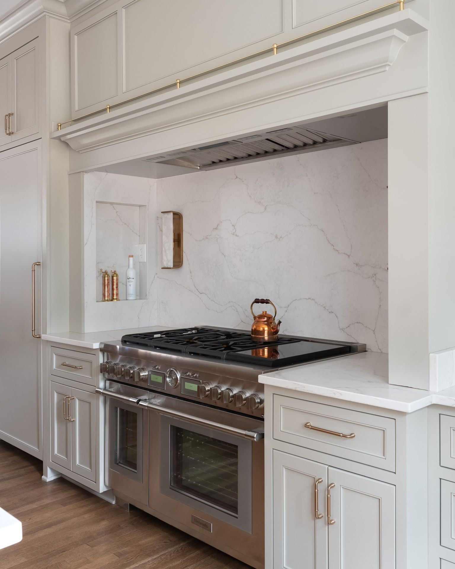Gray painted kitchen with white oak island by Designer Cabinets