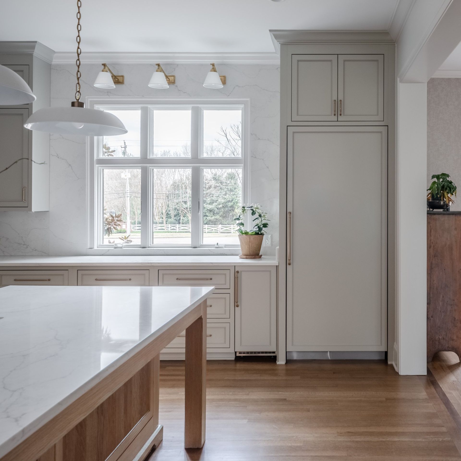 Gray painted kitchen with white oak island by Designer Cabinets