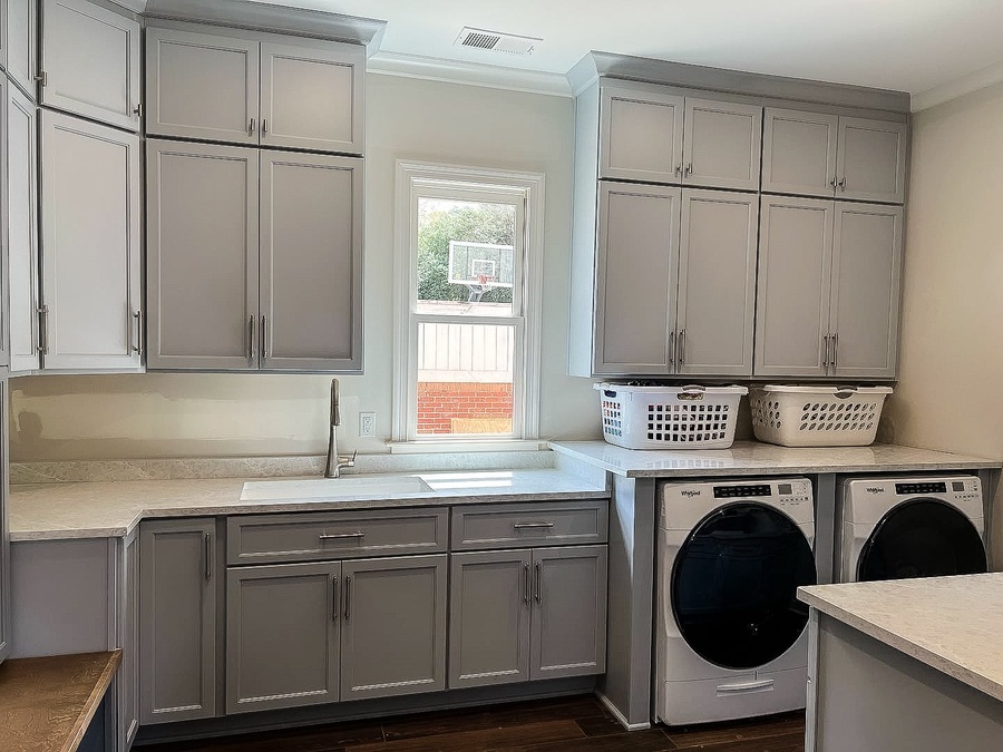 Gray shaker laundry cabinetry by Designer Cabinets